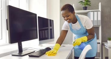 lady wiping office monitors with eco-friendly equipment